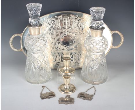 A near pair of Elizabeth II silver mounted thistle shaped cut glass decanters and stoppers, Birmingham 1966 and 1968, height 