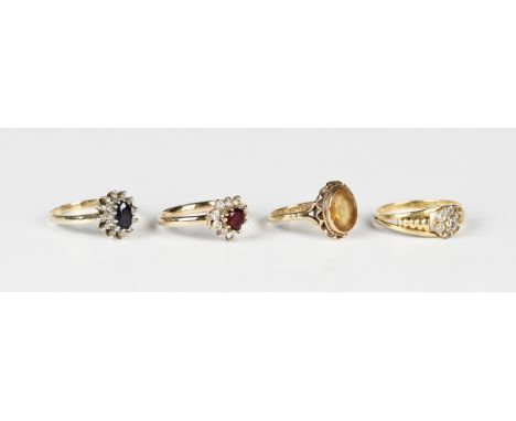 A 9ct gold, sapphire and diamond oval cluster ring, a 9ct gold ring, collet set with an oval cut citrine, Birmingham 1971, a 