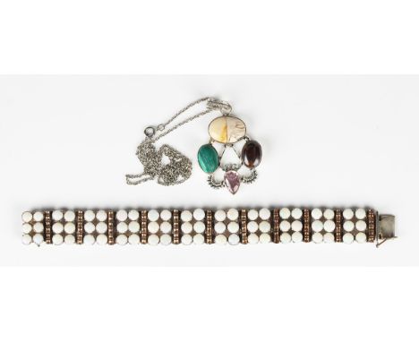 An opal bracelet in a panel shaped link design, mounted with eleven panels of six circular opals alternating with gilt baton 