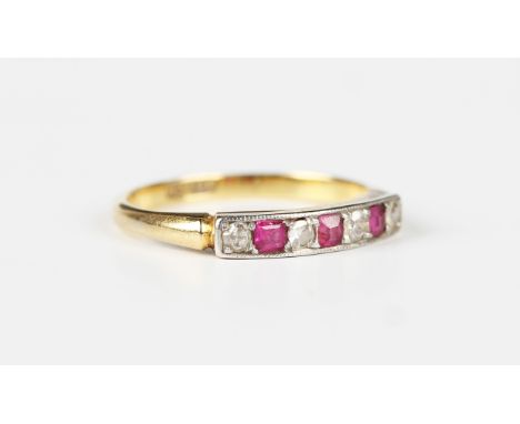 A gold and platinum, ruby and diamond seven stone ring, mounted with four cushion cut diamonds alternating with three square 