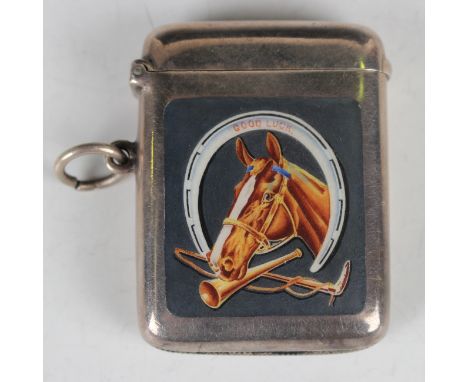 An Edwardian silver and enamel curved rectangular vesta case, the front enamelled with a horse's head, hunting horn and ridin