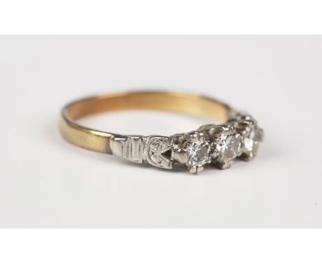 An 18ct gold and diamond three stone ring, mounted with a row of circular cut diamonds, Birmingham 1997, weight 2.9g, ring si