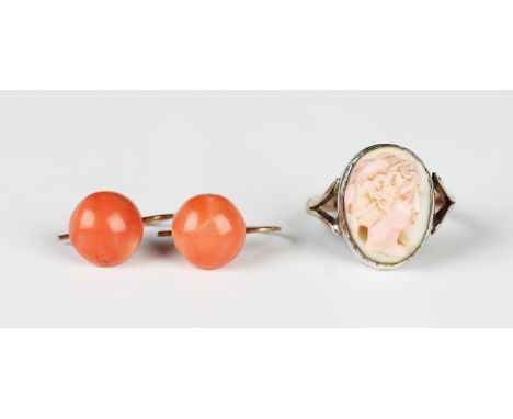 A pair of gold and coral earrings, each mounted with a coral bead, with wire hook fittings, unmarked, weight 2.3g, and a gold