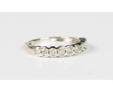 An 18ct white gold and diamond ten stone half-hoop eternity ring, mounted with a row of circular cut diamonds, detailed '750 