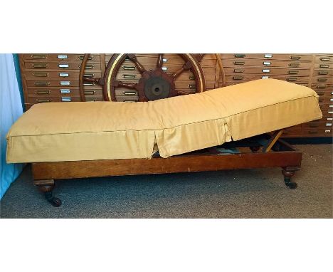 Late 19th century Mahogany Daybed, raised on ring turned legs of which retain the original porcelain castors. This daybed has