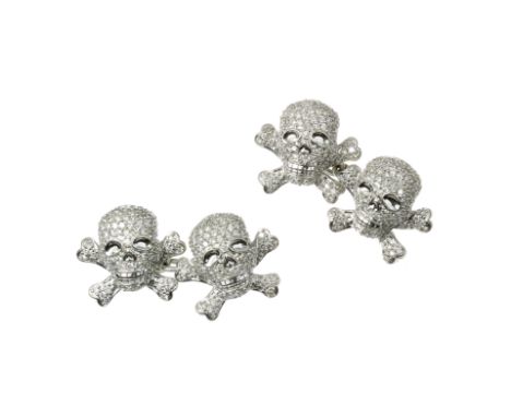 A PAIR OF SKULL AND CROSSBONES 'JOLLY ROGER' DIAMOND CUFFLINKS in 18ct white gold, each designed as two skull and crossbones 