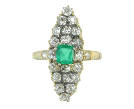 AN ANTIQUE EMERALD AND DIAMOND DRESS RING in high carat yellow gold, set with a central step cut emerald of 0.60 carats, surr