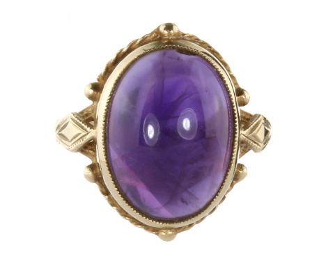 A VINTAGE AMETHYST DRESS RING, 1972 in yellow gold set with an oval cabochon amethyst of 8.70 carats. Full British hallmarks,