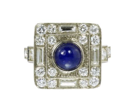 AN ART DECO BLUE SAPPHIRE AND DIAMOND DRESS RING in platinum, set with a central round cabochon blue sapphire, accented by fo