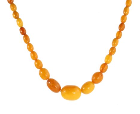 A NATURAL AMBER BEAD NECKLACE comprising a single row of sixty graduated polished oval beads up to 26mm, with a silver gilt c