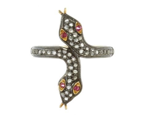A RUBY AND DIAMOND SNAKE RING designed as two snakes' heads coiled next to each other, jewelled with rose cut diamonds and ru