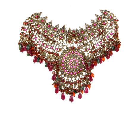 A LARGE GEM SET INDIAN NECKLACE jewelled with paste stones and suspending cabochon ruby and emerald drops.