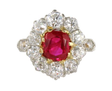 AN ANTIQUE BURMA NO HEAT RUBY AND DIAMOND CLUSTER RING in 18ct yellow gold, set with a central oval cut ruby of 1.58 carats, 