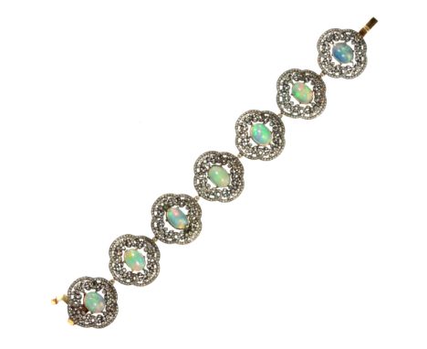 AN OPAL AND DIAMOND BRACELET comprising seven quatrefoil links, each set at the centre with an oval cabochon opal, and surrou