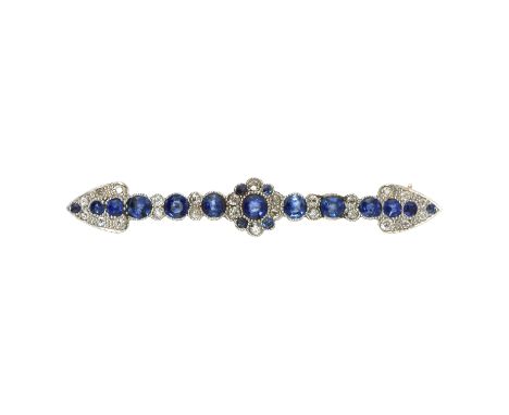 AN ANTIQUE SAPPHIRE AND DIAMOND BAR BROOCH in high carat gold set with a central sapphire and diamond cluster, within a band 