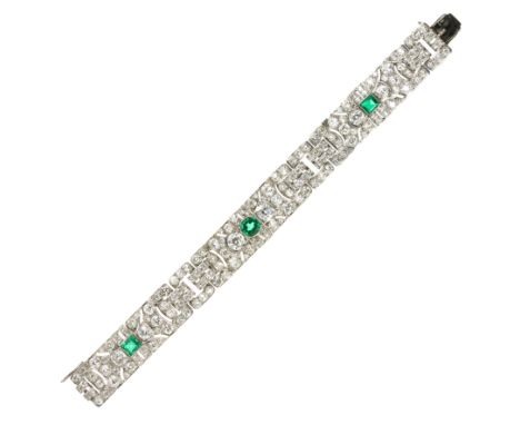 AN ART DECO EMERALD AND DIAMOND BRACELET in white gold or platinum, each of the three principal motifs set with a round or st