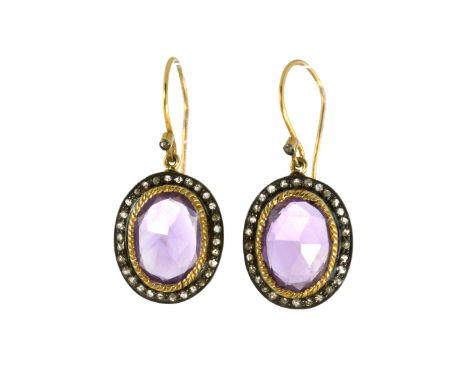 A PAIR OF AMETHYST AND DIAMOND CLUSTER EARRINGS in gold and silver, each set with an oval, rose cut amethyst surrounded by a 