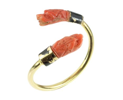 AN ANTIQUE ART DECO CARVED CORAL AND BLACK ENAMEL BANGLE in high carat yellow gold, the incomplete band design terminated at 