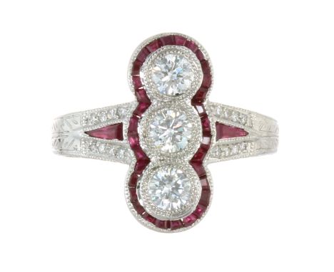 A DIAMOND AND RUBY DRESS RING in platinum or white gold, set with a row of three round cut diamonds within a border of calibr