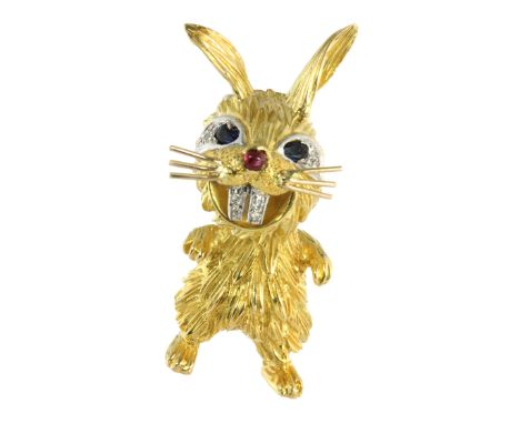 A VINTAGE RUBY, SAPPHIRE AND DIAMOND RABBIT PENDANT, KUTCHINSKY 1969 in 18ct yellow gold, designed as a bunny, the eyes set w