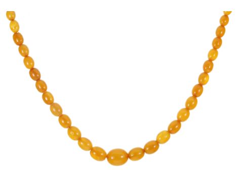 A NATURAL AMBER BEAD NECKLACE comprising a single row of fifty graduated polished oval beads up to 16.5mm, with a silver gilt