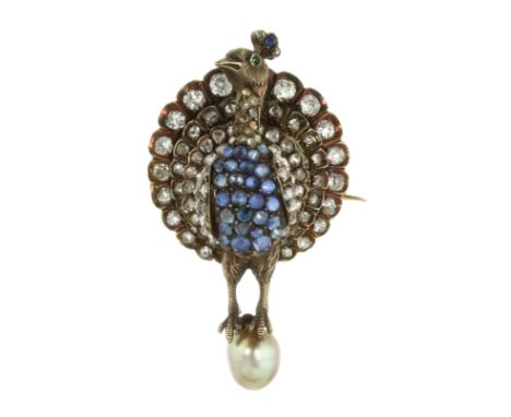 AN ANTIQUE PEARL, DIAMOND, SAPPHIRE AND EMERALD PEACOCK BROOCH / PENDANT in high carat yellow gold and silver, designed as a 