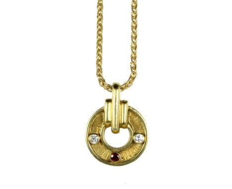 A VINTAGE RUBY AND DIAMOND PENDANT, KUTCHINSKY in 18ct yellow gold, the circular motif with textured surface, jewelled with t