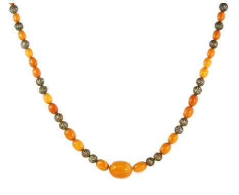 AN ANTIQUE NATURAL AMBER BEAD NECKLACE comprising a single row of forty-one graduated polished oval beads up to 25mm, with tw