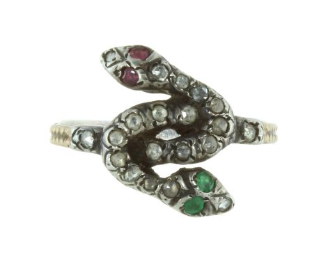 A RUBY, EMERALD AND DIAMOND DOUBLE SNAKE RING in yellow gold and silver, designed as two interwoven snakes, their bodies jewe