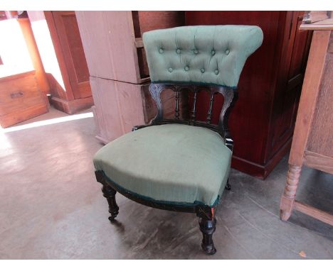 A late Victorian ebonised bedroom chair with gilt relief and ceramic castors 