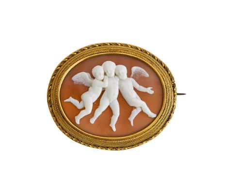 A MID VICTORIAN SHELL CAMEO BROOCH CIRCA 1860The oval shell cameo carved with a trio of cherubs in flight after Thorvaldsen, 