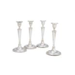 A SET OF FOUR GEORGE III SILVER CANDLESTICKS