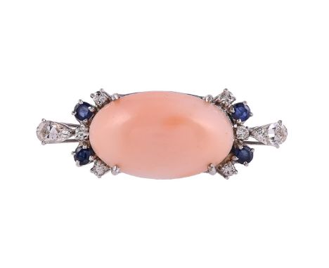 Y A CORAL, SAPPHIRE AND DIAMOND DRESS RING The oval cabochon coral between circular cut sapphire and brilliant cut and pear c