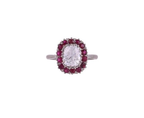 A DIAMOND AND RUBY CLUSTER RINGThe cushion shaped modified brilliant cut diamond weighing 2.12 carats within a surround of ci