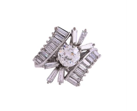 A 1970S DIAMOND DRESS RINGThe principal old European cut diamond weighing 1.32 carats, with crossover graduated baguette cut 