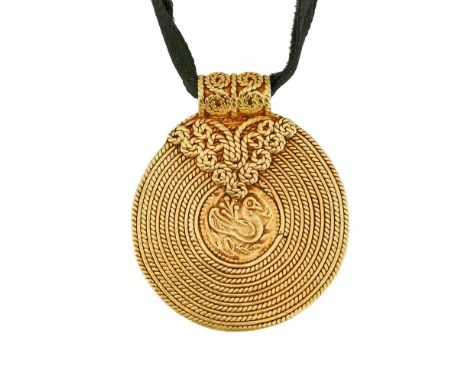 AN INDIAN GOLD COLOURED DISC PENDANTThe circular pendant of coiled polished and rope twist wire, centred with a chased bird a