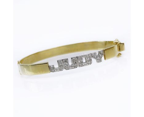 Vintage 14 Karat Yellow Gold Hinged Bangle Bracelet accented with Small Pave Set Diamonds Spelling "Judy". Signed 14K. Good v