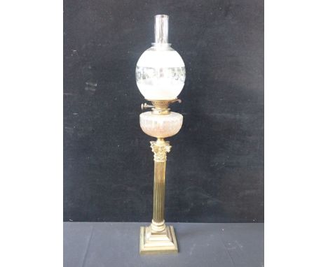 A VICTORIAN BRASS CORINTHIAN COLUMN OIL LAMP with cut glass reservoir and frosted and engraved globe 85cm high overall