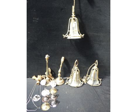THREE EDWARDIAN GILDED BRASS HANGING LIGHTS with frosted glass shades, 29 cms high, with two candlestick style brass table la