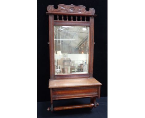A LATE VICTORIAN MAHOGANY OVER BASIN MIRROR with towel rail, and hinged compartment for brushes etc