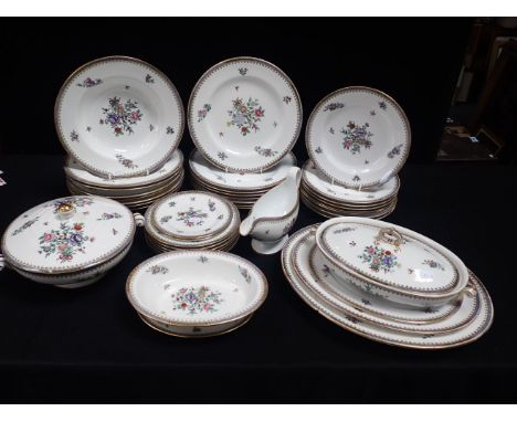 AN EDWARDIAN SPODE PART DINNER SERVICE, RETAILED BY GOODE &amp; CO floral decoration with gilt border (some wear and damage)