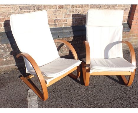 A PAIR OF MODERN LIGHT WOOD CANTILEVER ARMCHAIRS with cream cushions 66cm wide