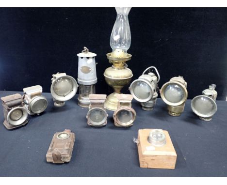 A COLLECTION OF BICYCLE LAMPS with a safety lamp, an oil lamp and two torches