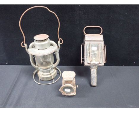 A VINTAGE BICYLCLE LAMP together with a carriage lamp and another
