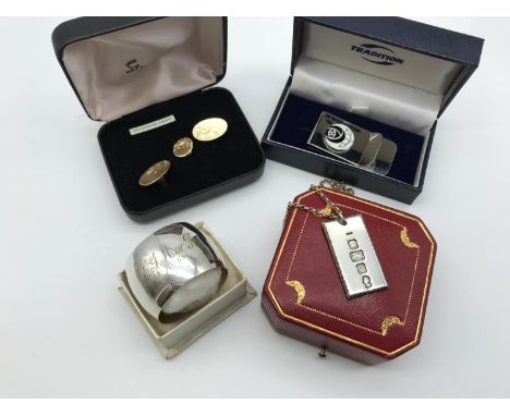 A mixed lot to include; London silver ingot with silver chain, EP napkin ring, McIntosh money clip &amp; plated cuff links 