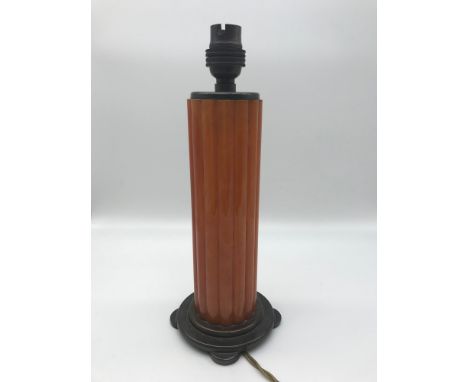 An Art Deco table lamp styled with Original orange reeded bakelite stem. Bronze base and top. 