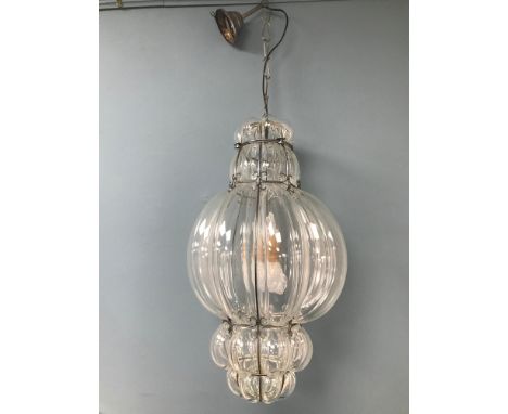 A Large interior glass and metal ceiling light. 