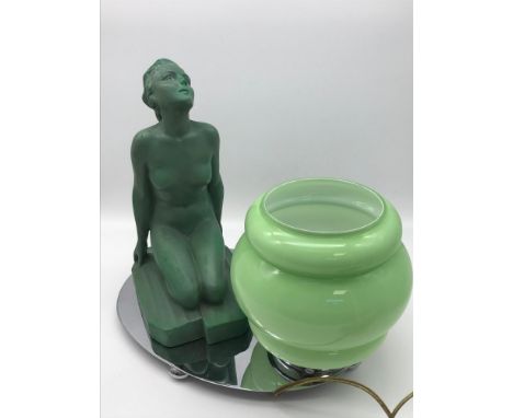 An Art Deco lady kneeling figurine lamp. Styled with an Art Deco green shade and chrome base. Stands 26cm 
