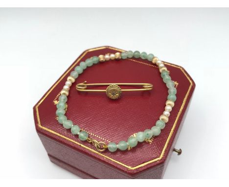 A 9ct gold ladies Bangle, designed with jade, pearl and gold spheres, together with a 9ct gold evening brooch. 