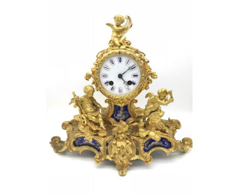 A Large Ormula French gilt metal mantle clock, Ornately designed with cherubs, Wreaths and birds. Has three porcelain cherub 